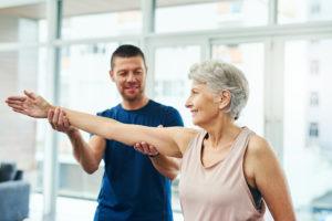 physiotherapist working with a senior female patient