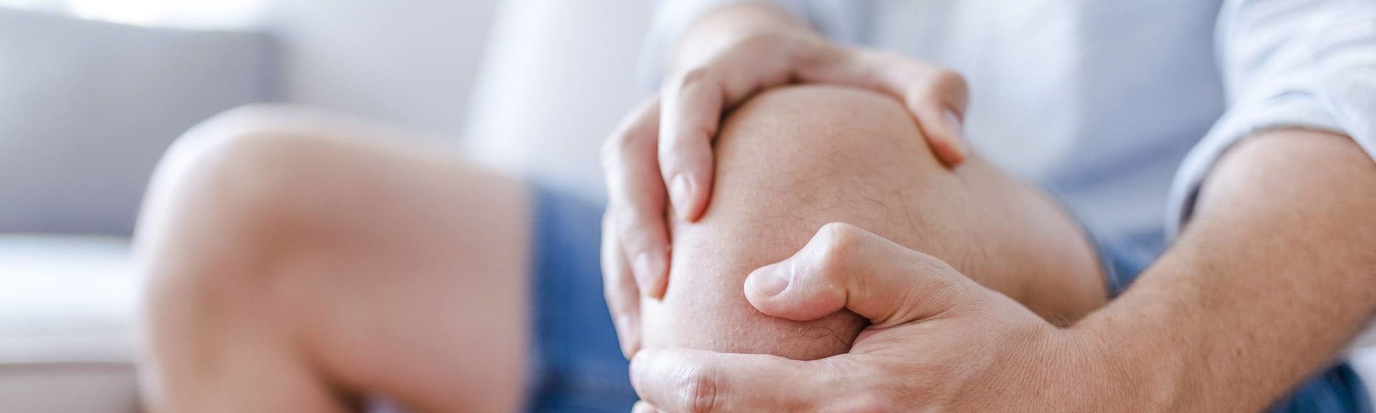 A man massaging his painful knee