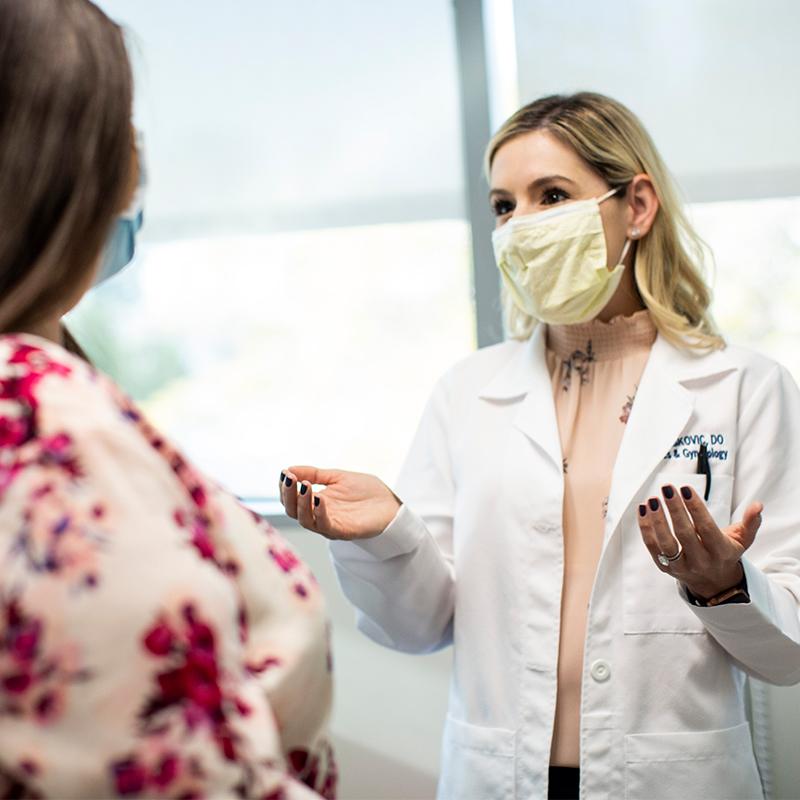 OBGYN speaking with her patient in the office