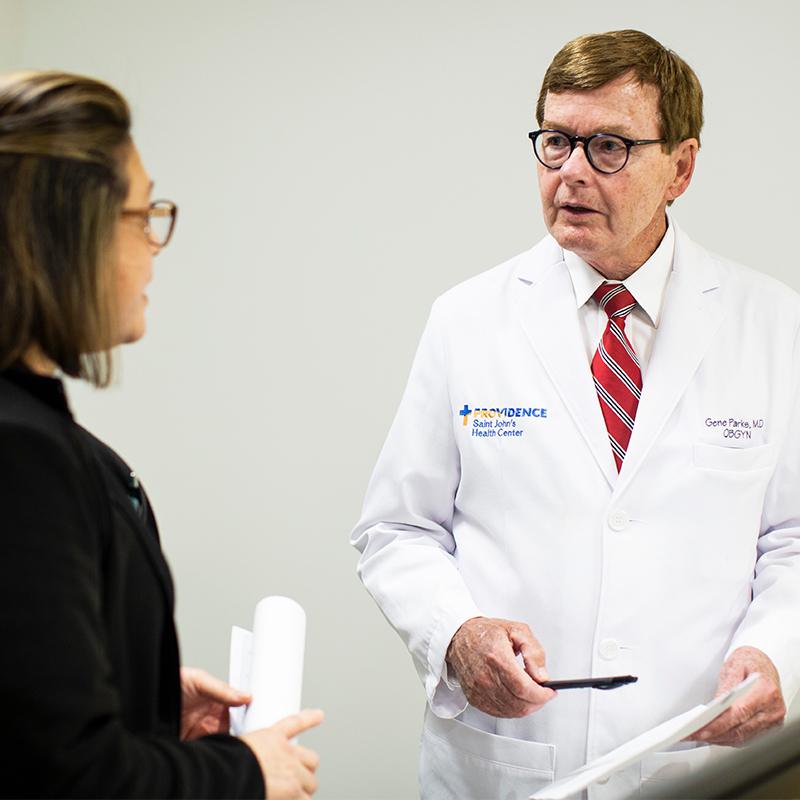 Physician speaking with a healthcare worker