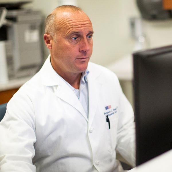 doctor researching on a computer