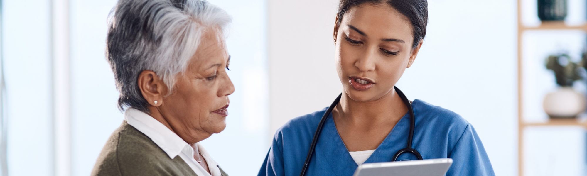 young doctor showing tablet during a consultation to patient